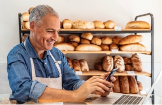 happy-bakery-owner-taking-pictures-of-new-website